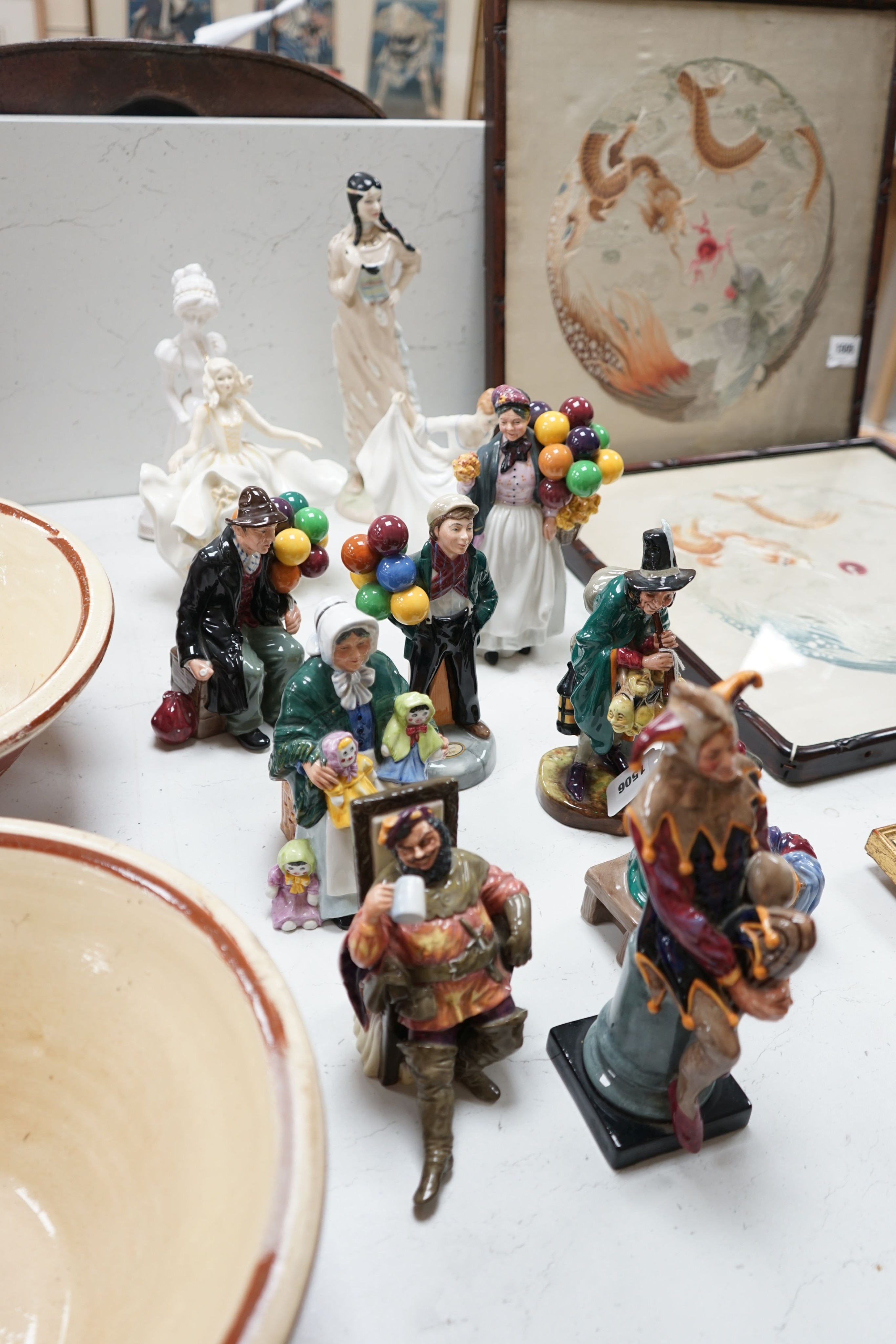 Eleven Royal Doulton figures - The Jester H.N. 2016, The Foaming Quart H.N. 2162, Silks and Ribbons HN 2017, The Rag Doll Seller HN 2944, The Mask Seller H.N. 2103, Balloon Boy HN 2934, The Balloon Man HN 1954, Biddy Pen